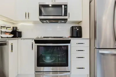 a kitchen with a stove and a microwave at Luxury Elegant Full house Escape Premium Comfort in Mississauga
