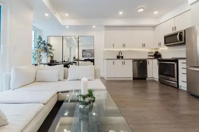 a living room with a white couch and a table at Luxury Elegant Full house Escape Premium Comfort in Mississauga