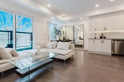 a living room with a white couch and a glass table at Luxury Elegant Full house Escape Premium Comfort in Mississauga