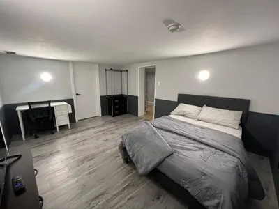 a bedroom with a large bed and a desk at Prime Location Studio with Separate amenities in London