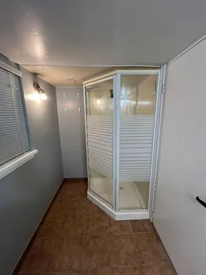 a walk in closet with a glass door at Prime Location Studio with Separate amenities in London