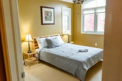 a bedroom with a bed and two lamps and a window at The Bards Roost - 3BR King Ensuite Family Friendly in Stratford