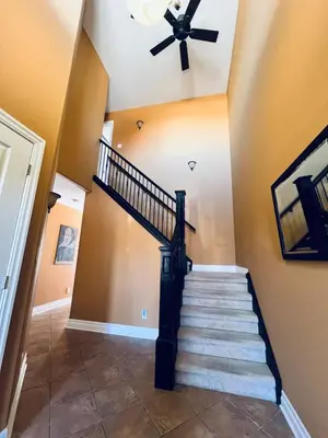 a staircase in a home with a black rail and a ceiling at The Bards Roost - 3BR King Ensuite Family Friendly in Stratford