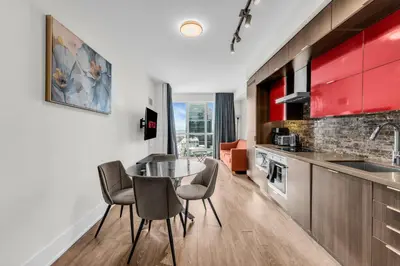 a kitchen and dining room with a table and chairs at Eleve Toronto Residences in Toronto