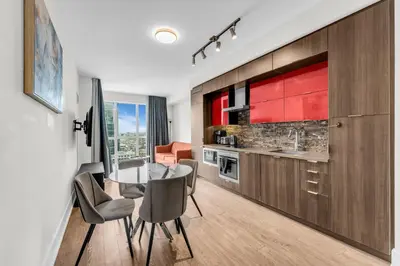 a kitchen and dining room with a table and chairs at Eleve Toronto Residences in Toronto