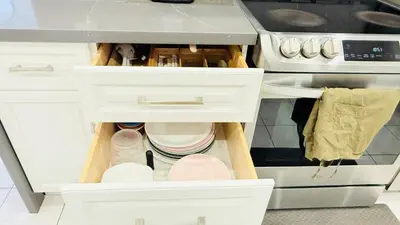 a kitchen with white cabinets and a stove at Bright 3BR Home in Richmond Hill free parking in Richmond Hill