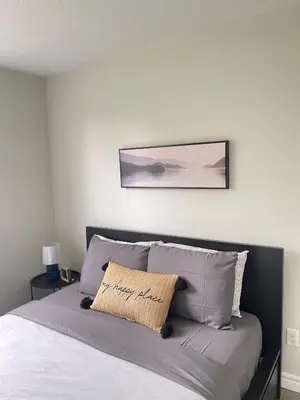 a bedroom with a bed with a picture on the wall at Hamilton Haven Private Rooms in Hamilton