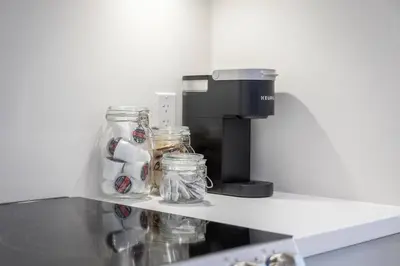 a coffee maker and jars on a shelf in a kitchen at Lovely Open Concept Friday Harbor Resort Condo in Innisfil