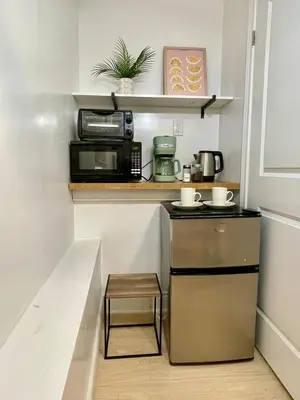 a small kitchen with a stove and a microwave at The Scholar Suite Modern Comfort Near Western U in London