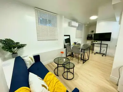 a living room with a couch and a table at The Scholar Suite Modern Comfort Near Western U in London