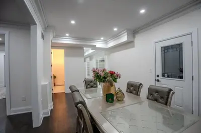 a dining room with a table with a vase of flowers at Perfect Group Getaway Large House with Style in Bolton