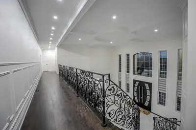 a hallway with a spiral staircase in a building at Perfect Group Getaway Large House with Style in Bolton