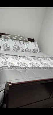 a bed with white sheets and pillows on it at Beautiful Master bedroom with private 5PC ensuite washroom in Mississauga
