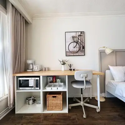 a room with a desk with a microwave and a bed at Cozy Studio with 2 Beds & Private Bathroom in Toronto