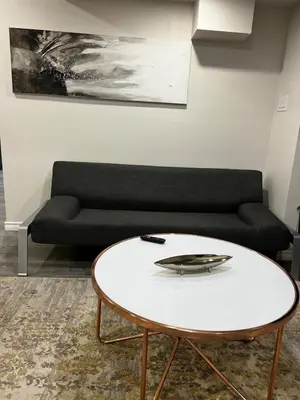 a living room with a couch and a table at Beautiful Newly Built 2 Bedrooms Basement Apartment in Milton ,Sleeps 6 in Milton