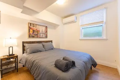 a bedroom with a bed and a window at 2min to DT, Cowboys, Full-Kitchen, 65 inch TV in London