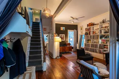 a room with a staircase and a living room at Spacious 3 Bedroom Toronto Home with Piano in Toronto