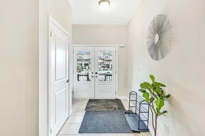 a hallway with a white door and a rug at Spacious 3BR House with Modern Comforts in Thorold