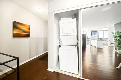 a kitchen with a white refrigerator in a room at Lux Penthouse Retreat Near Yorkville with Parking in Toronto