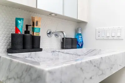 a white counter top with a sink in a kitchen at Luxury Yorkville Two Bedroom Condo With Views and Parking in Toronto