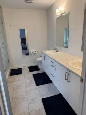 a white bathroom with a sink and a toilet at Charming Short-Term Stay Near Downtown Fergus & Elora Mill in Fergus