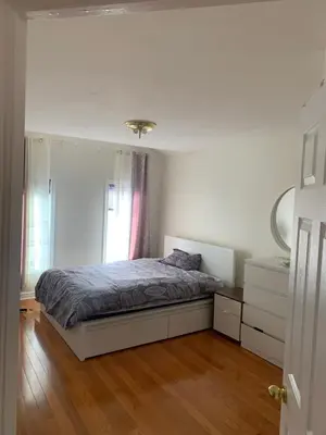 a bedroom with a bed and a dresser and a mirror at Cozy House in Richmond Hill