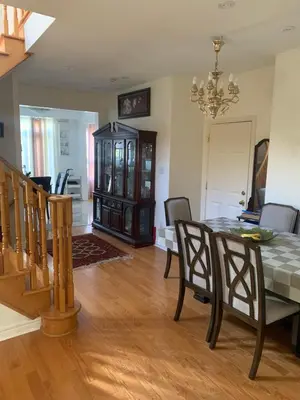 a dining room with a table and chairs at Cozy House in Richmond Hill