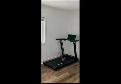 a room with a treadmill and a laptop on it at Cozy Fort Erie crystal Beach house in Fort Erie