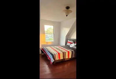 a bedroom with a bed and a window at Cozy Fort Erie crystal Beach house in Fort Erie