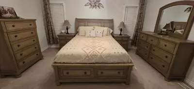 a bedroom with a bed with two dressers and a mirror at Paradise Haven in Arthur