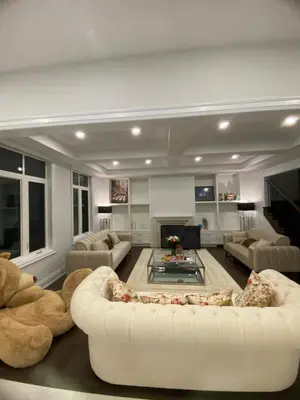 a living room with a white couch and a fireplace at Modern Living near Yonge St in Toronto