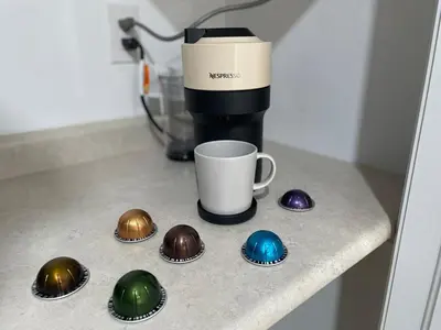 a counter with a coffee cup and four chocolate eggs at The Pantry Suite - Cozy Basement Stay in Mississauga
