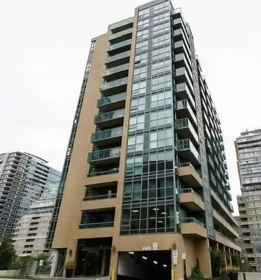 a tall building with many windows in a city at Liberty Village Condo Lake and BMO Field View in Toronto