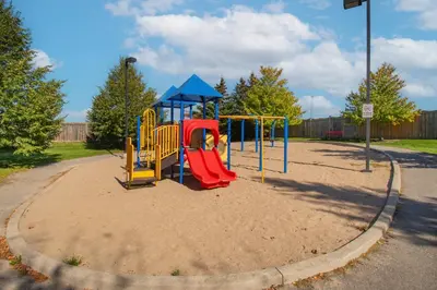 a playground with a slide in a park at Cozy Barrie retreat near lake Simcoe and parks in Barrie
