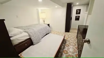 a bedroom with a bed and a open door at Multi-level home near Squareone, Airport, 3Parking in Mississauga