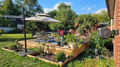 a garden with a table and an umbrella and plants at Multi-level home near Squareone, Airport, 3Parking in Mississauga