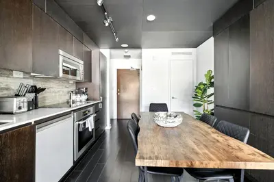 a kitchen with a wooden table in a room at Modern CityPlace Retreat King Bed & Balcony in Toronto