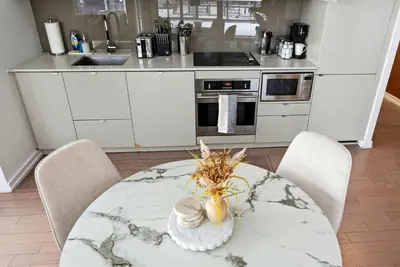 a kitchen with a table with a vase on it at Stunning 2BR Downtown Condo w Huge Private Patio in Toronto