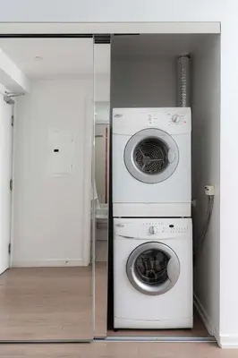 a washing machine and a washer in a room at Designer 1BR Condo Entertainment District in Toronto