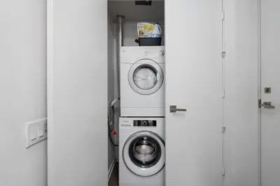 a washer and dryer sitting in a room at Modern 2BR in the Entertainment Hub with Parking in Toronto