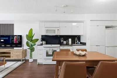 a kitchen with a table and a dining room at Modern Downtown Retreat Cozy Living & City Views in Toronto