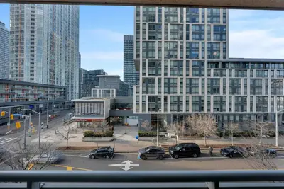 a view of a city with cars parked in a parking lot at Modern CityPlace Sky Home 2BR 2BA & Balcony in Toronto