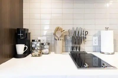 a kitchen counter with utensils on a counter top at Sleek Yorkville King Suite Sleeps 5 DT in Toronto