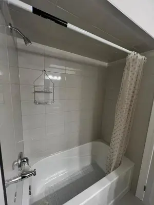 a bathroom with a bath tub with a shower at 3bed Bright Oakville Townhome with balcony, office in Oakville