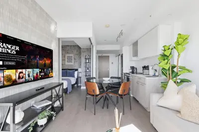 a kitchen and living room with a table and chairs at Stunning Family-Friendly Parking & City Views in Toronto