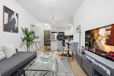 a living room with a couch and a table at Cozy 1BR Condo w Private Patio for Morning Coffee in Toronto