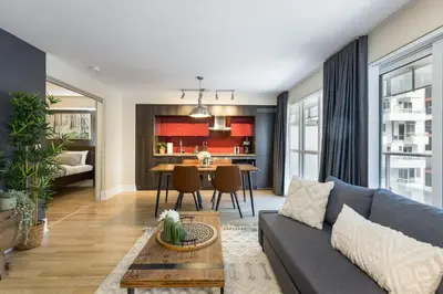 a living room with a couch and a table at Modern 1BR Retreat with Balcony & Parking in Toronto