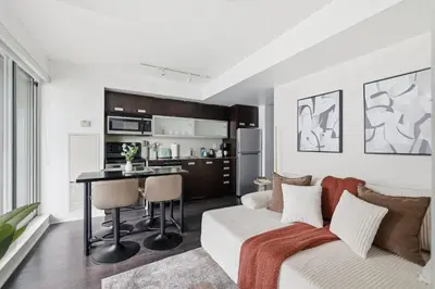 a living room with a couch and a table at Modern 1BR in Liberty Village Walk Score 90 in Toronto