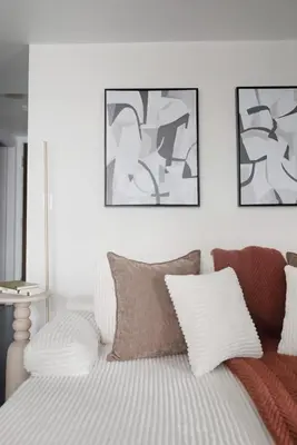 a bedroom with a bed with three pictures on the wall at Modern 1BR in Liberty Village Walk Score 90 in Toronto