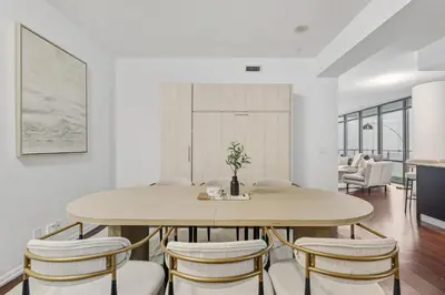a dining room with a table and chairs at Designer Bay Street Condo Sleep 6 in Toronto